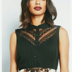 Black sleeveless blouse with sheer lace yoke